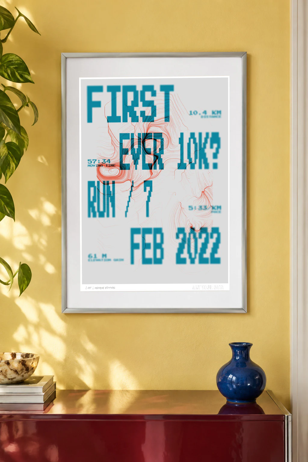 Framed personalised running artwork displayed in a yellow room